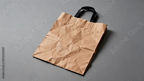 Brown paper bag with black handles