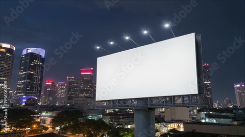 Blank Billboard in Cityscape at Night.