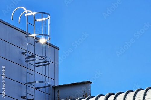 Canvastavla Minimal fixed aluminum ladder with a safety cage with blue sky background
