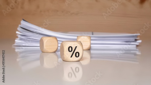 Percentage symbol on a wooden block with papers in the background