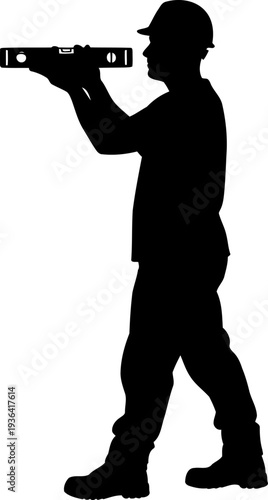 Construction worker checking alignment with spirit level tool