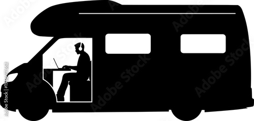 Digital nomad working on laptop inside camper van