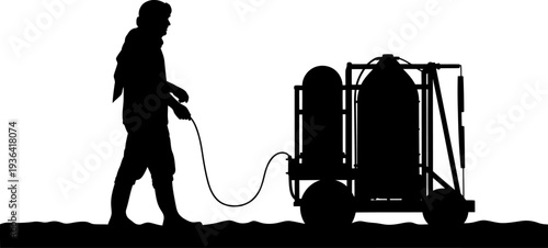 Laborer pulling heavy industrial gas cylinder trolley