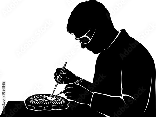Scientist using tweezers to examine small fossil specimen