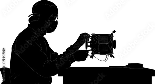 Aerospace technician assembling a small satellite in a clean room lab