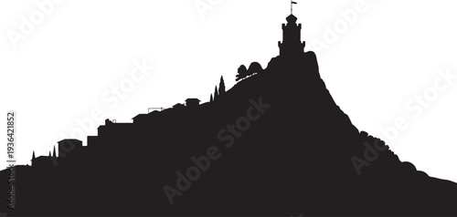 Silhouette of a historic European town on a hill with a prominent tower