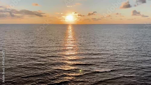 Amazing sunset view with the sun's reflection creating a sparkling path on the tranquil sea water