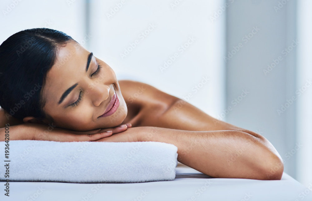 Fototapeta premium Relax, girl and smile on massage table at spa for luxury pamper, muscle therapy or space. Hospitality, woman and peaceful at wellness resort for holistic treatment, body care or zen for stress relief