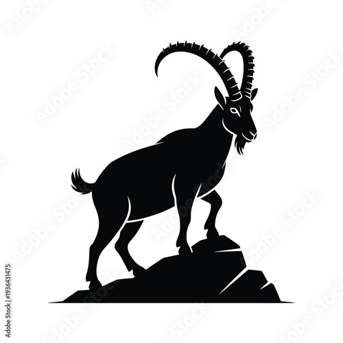 A striking black silhouette of an ibex standing on rocky terrain