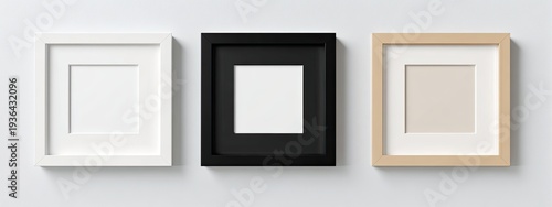 Three square picture frames, white, black, and beige, against a white wall