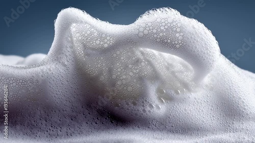 Soft and delicate foam creates mesmerizing patterns in a tranquil studio setting. Each bubble and wave breathes life into a stunning display of white beauty, inviting calmness and wonder