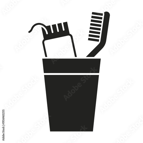 Black and white toothbrush and comb in a cup