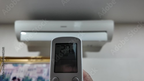 Turn on the air conditioner with the remote and adjust the temperature.