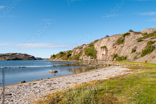Granite rocky coast at Valön naturreservat, Bohuslän, Sweden, with coastal path and small beach near Valö Holme in west coast archipelago