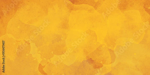 Abstract watercolor splashes in warm yellow and orange tones