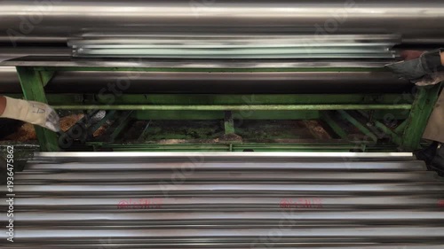 Corrugated zinc sheets are manufactured using large machinery.