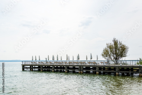 Wallpaper Mural Wooden pier with lounge chairs and umbrellas on Lake Garda Torontodigital.ca