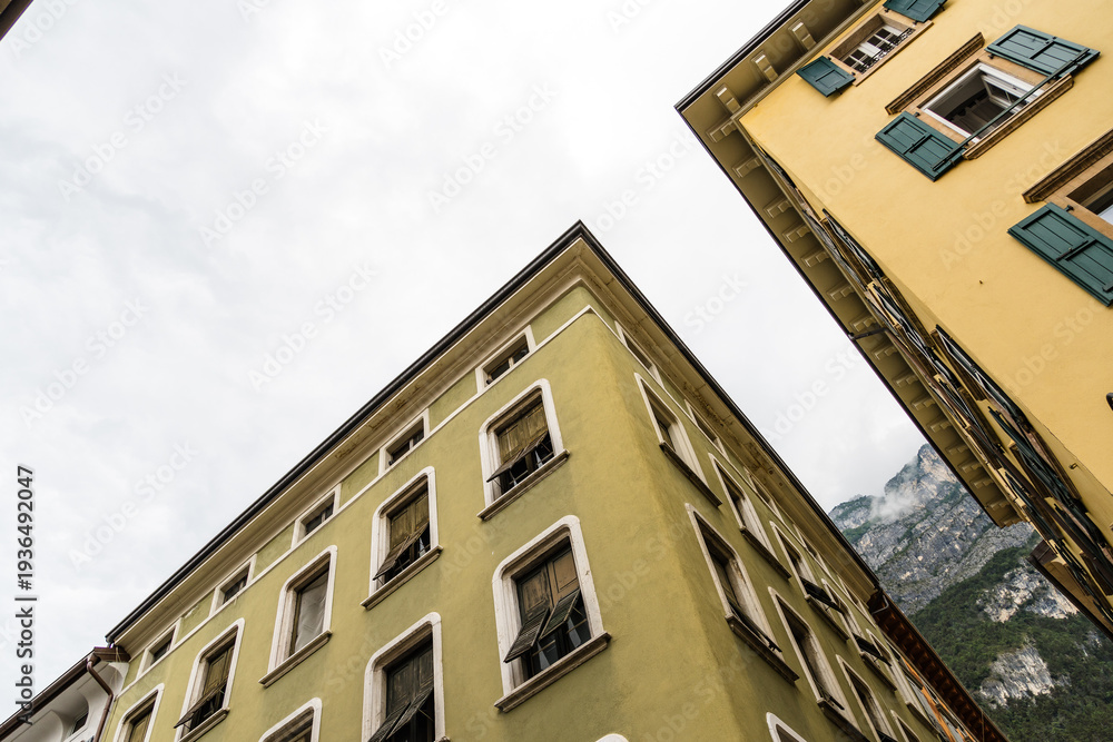 Fototapeta premium Buildings in Riva del Garda with shutters and cloudy sky