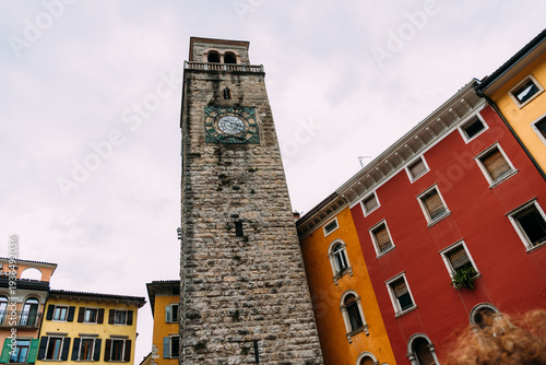 Wallpaper Mural Riva del Garda historic clock tower and colorful buildings under a cloudy sky. Torontodigital.ca
