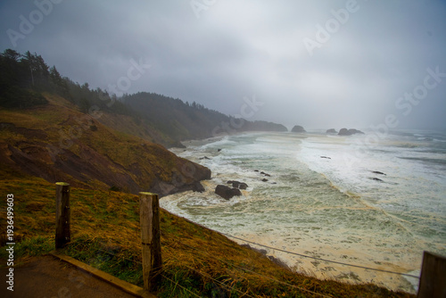 Indian Cove, Oregon Coast, the curving coastline and stormy seas breaking on shore.
