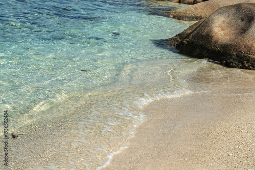 Bild auf Leinwand Gentle turquoise waves of the Indian Ocean caress the fine coral sand beach on L