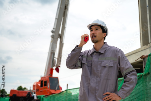 Tablou pe pânză Male Japanese site engineer working in housing project development construction