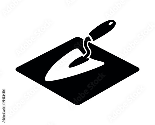 A black and white illustration of a trowel on a square plate