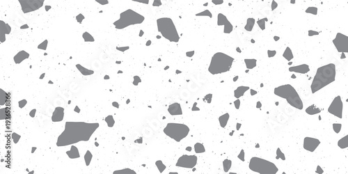 Gray irregular shapes scattered on white speckled background