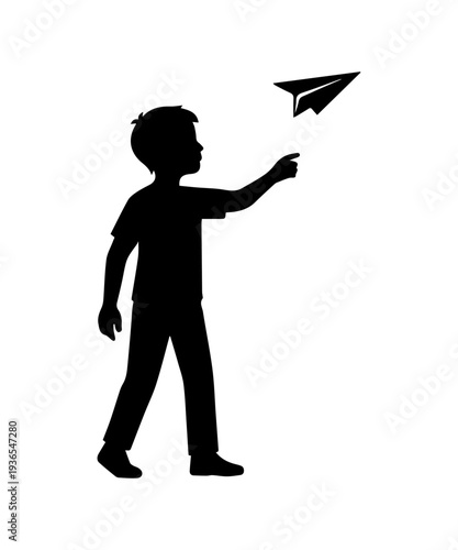Boy silhouette launching paper plane, dreaming big