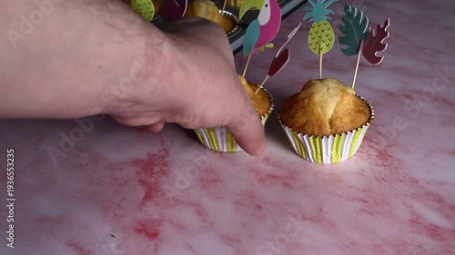 Homemade muffins on pink and grey background