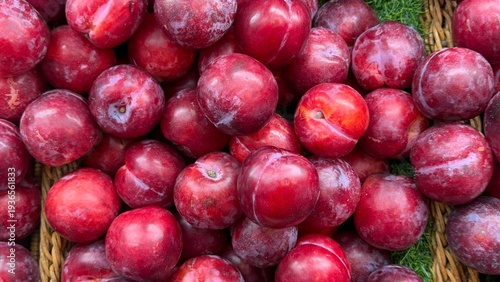 Canvas Print red plum on the basket in supermarket