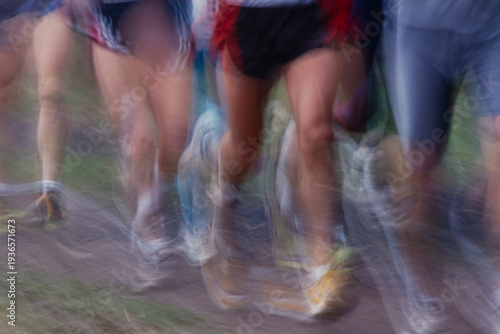 Cuadro en lienzo Energetic motion blur of runners sprinting on dirt path, dynamic action and speed in outdoor race event