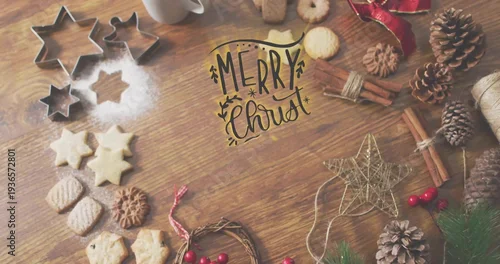 Obraz Arranging holiday bake on wood table, showing cookies, metal star cutters handwritten MERRY Christ