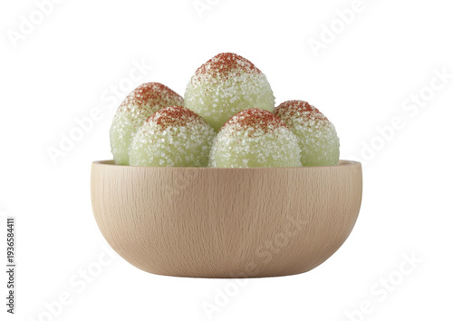 Spherical candies in wooden bowl, topped with powder