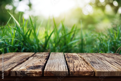 Rustic wooden table in serene outdoor setting with lush green grass