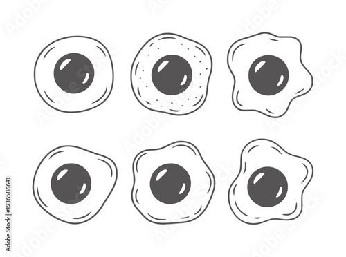 Six black and white of fried eggs with dark gray yolks
