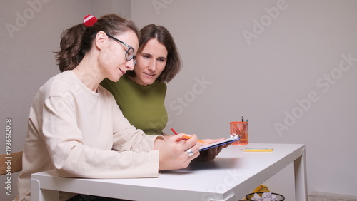 Принти на полотні Two women collaborating on financial planning, discussing paperwork, and managin