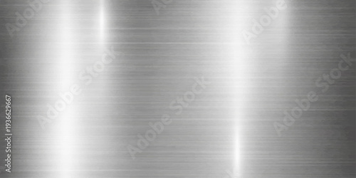 Abstract close-up view of a polished steel surface. The reflective metal gleams with the light, conveying a sense of modernity and industrial design. 