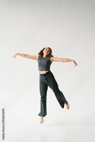Woman Spreading Arms Jumping Joy Freedom