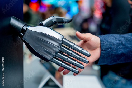 robot and human hands shaking, concept of humanoid and humans interaction and cooperation in the future