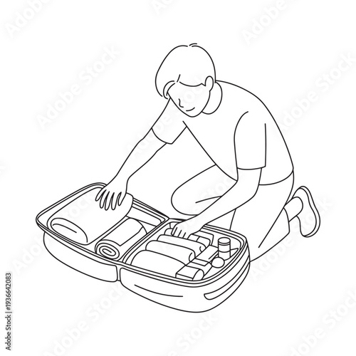 A person kneels while packing a suitcase with various travel items