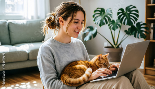 An authentic remote work life of a female freelancer multitasking with her feline companion.