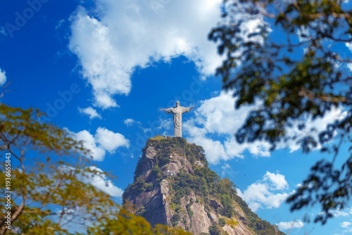 Принти на полотні Corcovado mountain framed by green foliage under a blue sky in Rio de Janeiro, Brazil