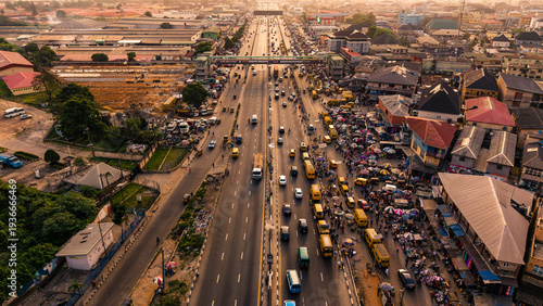 Lagos, Nigeria - 24 February 2026: Aerial view of the bustling Oshodi pedestrian overpass, where a vibrant tapestry of vehicles and markets unfolds in a lively symphony of urban energy.