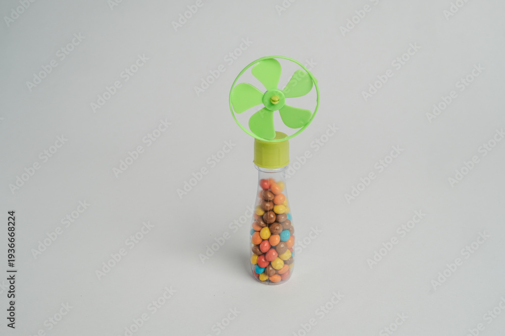 Fototapeta premium Colorful Candy Filled Handheld Mini Fan Isolated