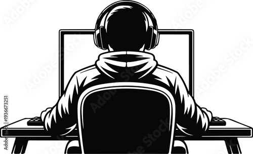 Person wearing headphones sitting at a desk with a computer monitor viewed from behind