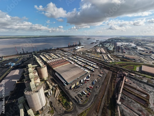 Immingham, United Kingdom - 15 March 2026: Aerial view of the port, where the Humber Estuary meets the industrial landscape, a stark contrast of dark coal against the bright sky.
