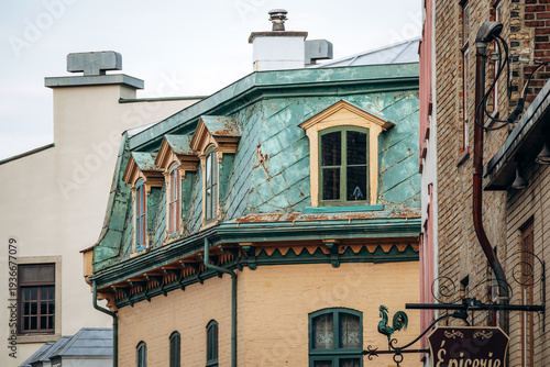Quebec City, Canada - August 24, 2025: Historic building with green copper mansard roof and dormer windows in Old Quebec