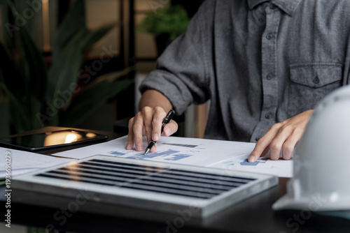 Business man generates renewable energy innovations in eco office workspace