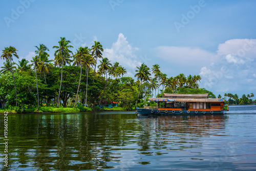 Traditional house boat is anchored on the shores of a fishing lake in Kerala's Backwaters, India.
